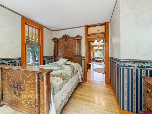 445 4th St, Ouray, CO 81427 - bedroom featuring wallpapered walls, wood finished floors, and crown molding