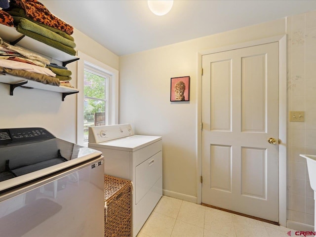 445 4th St, Ouray, CO 81427 - laundry room with washing machine and clothes dryer, baseboards, and light tile patterned flooring