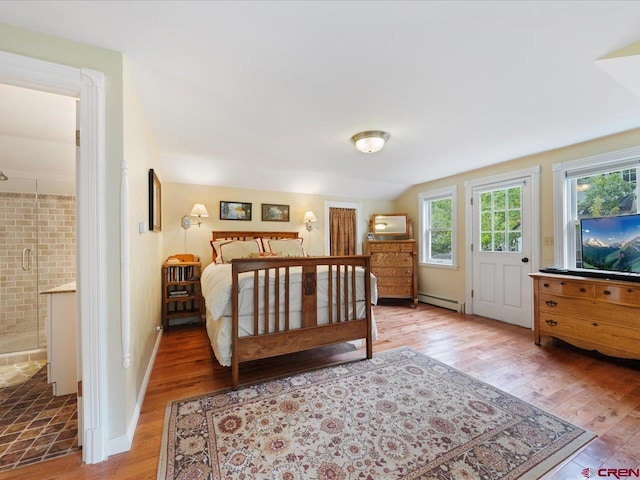 445 4th St, Ouray, CO 81427 - bedroom with a baseboard heating unit, wood finished floors, and ensuite bathroom