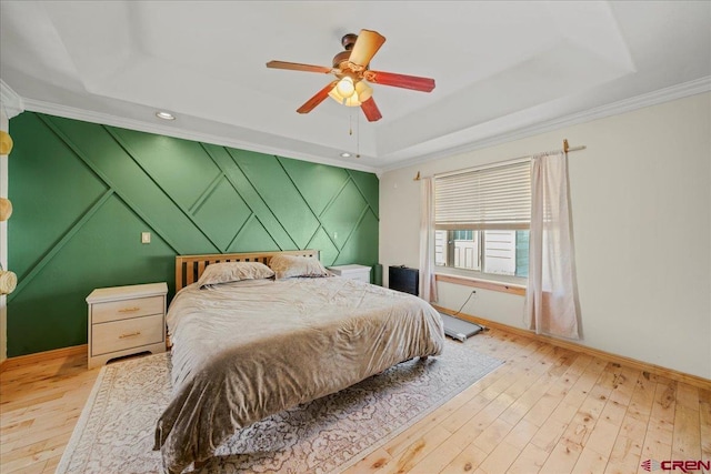 2224 American Way, Montrose, CO 81401 - bedroom with a raised ceiling, wood-type flooring, baseboards, crown molding, and a ceiling fan