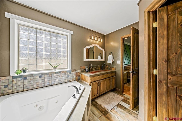 2224 American Way, Montrose, CO 81401 - bathroom with wood finished floors, vanity, and a tub with jets