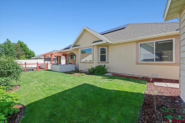 2224 American Way, Montrose, CO 81401 - rear view of property featuring roof mounted solar panels, a shingled roof, a pergola, and stucco siding