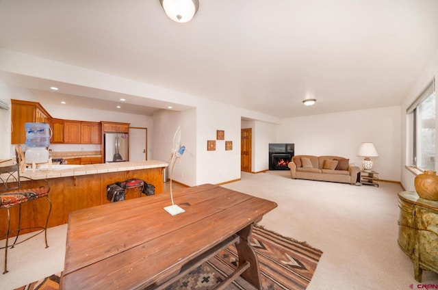 416 Amy Way, Ridgway, CO 81432 - dining space with light colored carpet, a lit fireplace, and recessed lighting