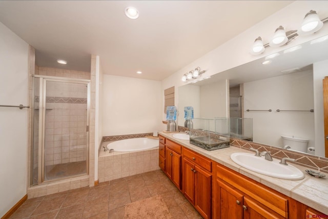 416 Amy Way, Ridgway, CO 81432 - full bathroom with double vanity, a garden tub, a shower stall, toilet, and tile patterned flooring