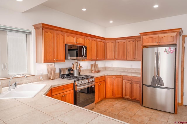 416 Amy Way, Ridgway, CO 81432 - kitchen with appliances with stainless steel finishes, a sink, tile counters, recessed lighting, and light tile patterned floors