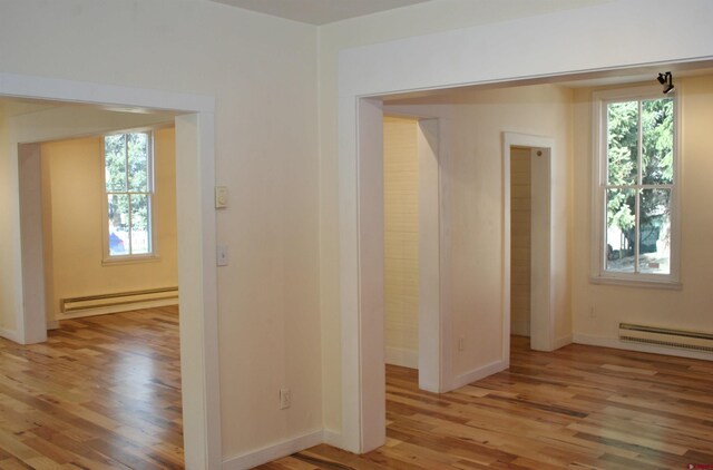 418 Elk Ave, Crested Butte, CO 81224 - spare room with a baseboard heating unit, plenty of natural light, and light wood-style floors