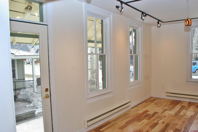 418 Elk Ave, Crested Butte, CO 81224 - doorway with baseboard heating, a baseboard heating unit, plenty of natural light, and light wood finished floors