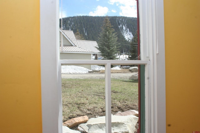 418 Elk Ave, Crested Butte, CO 81224 - doorway to outside featuring a forest view