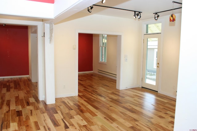 418 Elk Ave, Crested Butte, CO 81224 - spare room featuring a baseboard heating unit, track lighting, light wood-type flooring, and baseboards