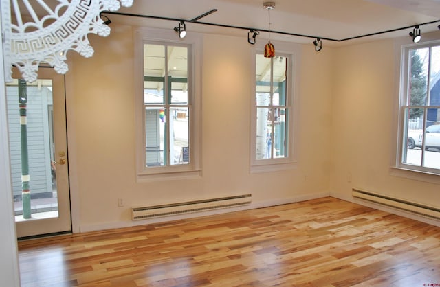 418 Elk Ave, Crested Butte, CO 81224 - empty room with baseboard heating, wood finished floors, and rail lighting