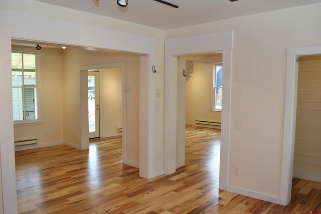 418 Elk Ave, Crested Butte, CO 81224 - unfurnished room featuring a baseboard radiator, baseboard heating, light wood finished floors, ceiling fan, and baseboards