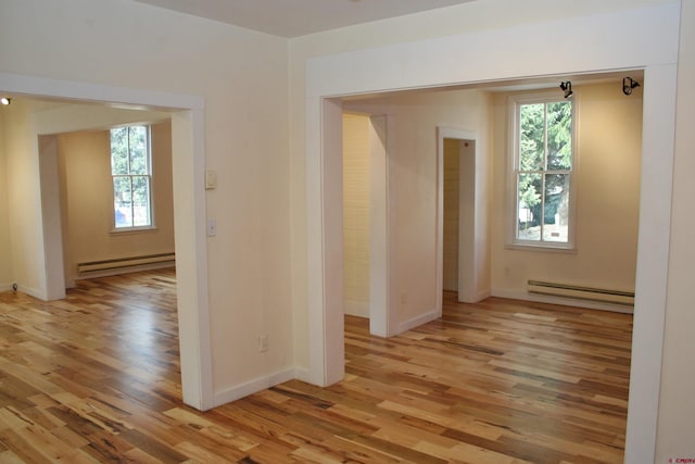 418 Elk Ave, Crested Butte, CO 81224 - spare room featuring baseboard heating, healthy amount of natural light, and light wood-style flooring