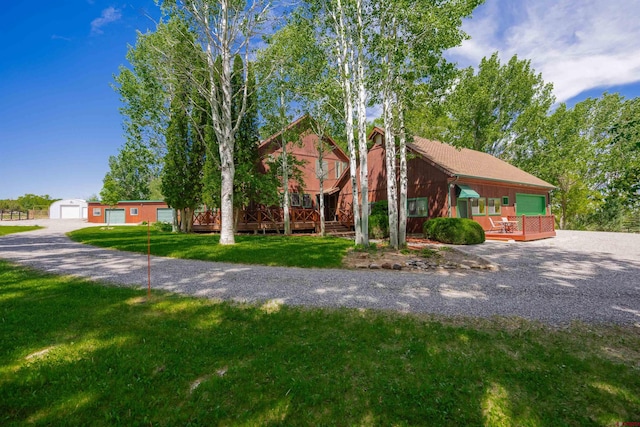60714 Oak Grove Rd, Montrose, CO 81403 - view of front of home with a front yard, a garage, a wooden deck, and an outdoor structure