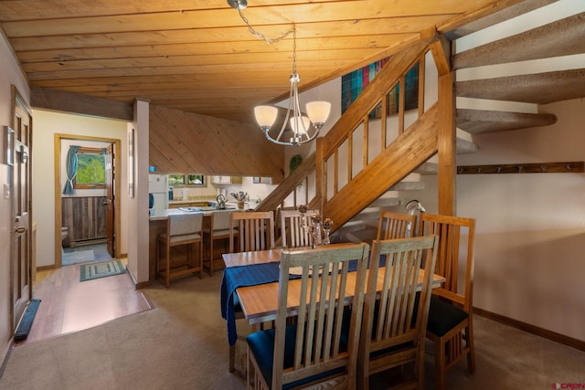 15 Marcellina Ln # 120, Mount Crested Butte, CO 81225 - dining space with carpet, a chandelier, stairs, wood ceiling, and baseboards