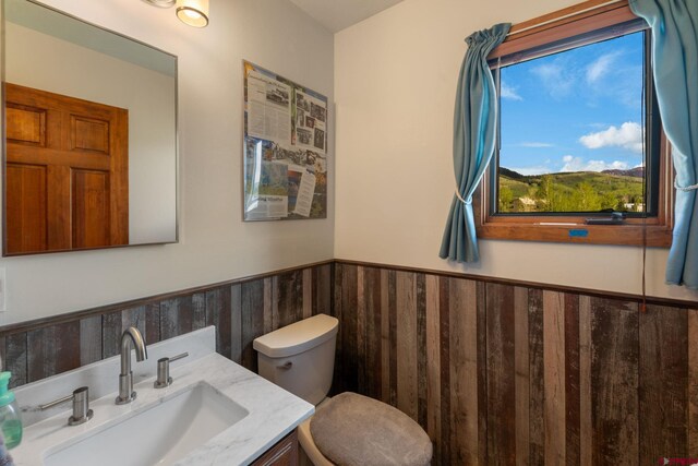 15 Marcellina Ln # 120, Mount Crested Butte, CO 81225 - bathroom featuring a wainscoted wall, toilet, and vanity