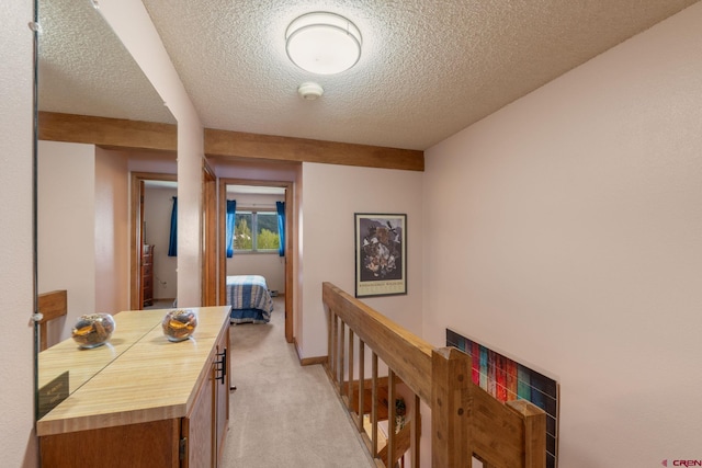15 Marcellina Ln # 120, Mount Crested Butte, CO 81225 - corridor featuring a textured ceiling, light colored carpet, and an upstairs landing