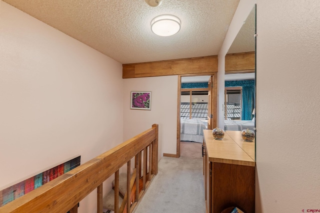 15 Marcellina Ln # 120, Mount Crested Butte, CO 81225 - corridor with light colored carpet, a textured ceiling, and an upstairs landing