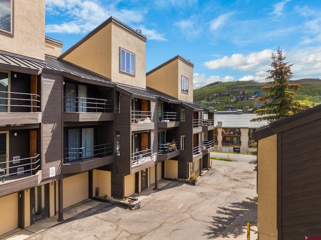 15 Marcellina Ln # 120, Mount Crested Butte, CO 81225 - view of building exterior with an attached garage and driveway