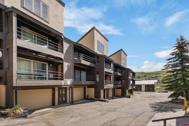 15 Marcellina Ln # 120, Mount Crested Butte, CO 81225 - view of apartment building / complex with an attached garage and driveway