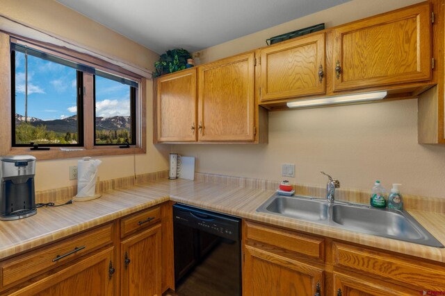 15 Marcellina Ln # 120, Mount Crested Butte, CO 81225 - kitchen featuring black dishwasher, a sink, light countertops, and brown cabinetry