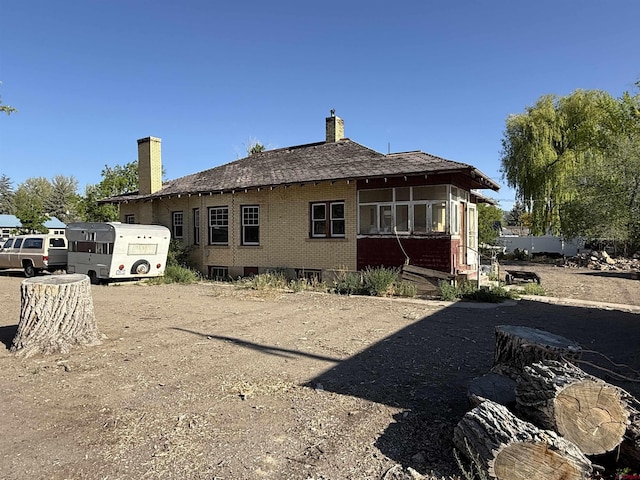840 Hastings St, Delta, CO 81416 - rear view of house with brick siding and a chimney