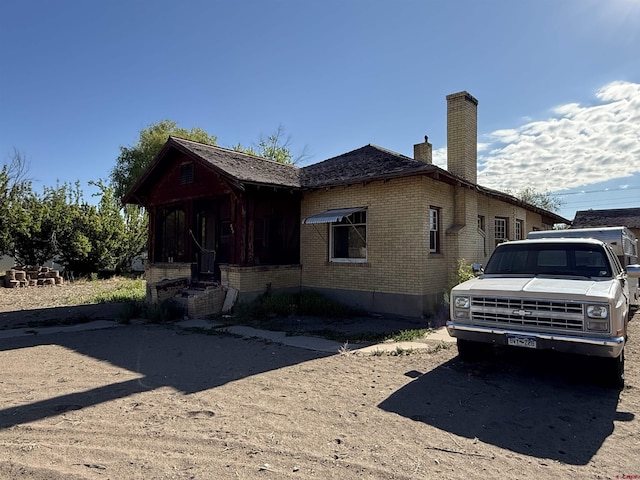 840 Hastings St, Delta, CO 81416 - view of front of house with brick siding and a chimney