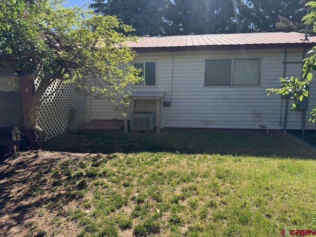 1010 N Dove St, Dove Creek, CO 81324 - rear view of property with a lawn, cooling unit, and metal roof