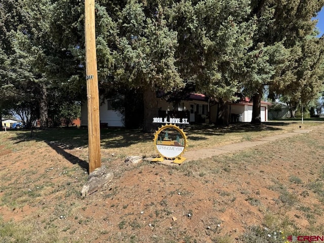 1010 N Dove St, Dove Creek, CO 81324 - view of grassy yard with an attached garage
