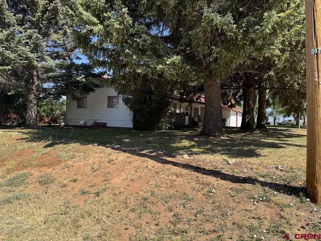 1010 N Dove St, Dove Creek, CO 81324 - view of green lawn with an attached garage