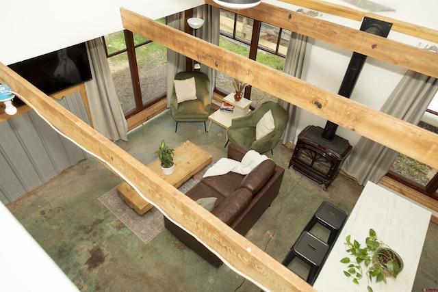 103 W 10 1/2 St, Creede, CO 81130 - living room featuring a wood stove, concrete flooring, and healthy amount of natural light
