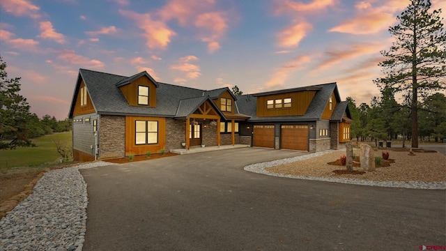 17 Coyote Ct, Ridgway, CO 81432 - view of front of property featuring stone siding, driveway, a garage, and a shingled roof
