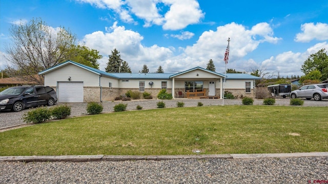 180 SE Frontier Ave, Cedaredge, CO 81413 - ranch-style home with a porch, a garage, a front lawn, brick siding, and driveway