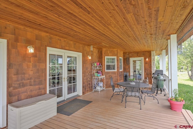 101 E Silver Sage Dr, Crested Butte, CO 81224 - wooden terrace with french doors, outdoor dining area, and area for grilling