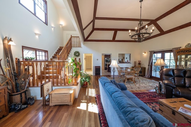 101 E Silver Sage Dr, Crested Butte, CO 81224 - living area with high vaulted ceiling, a chandelier, stairway, wood finished floors, and beamed ceiling