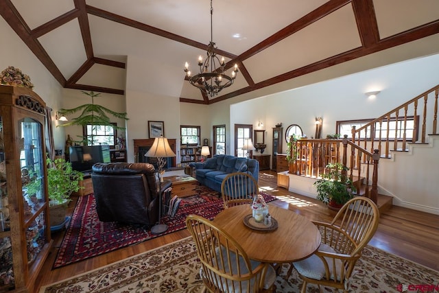 101 E Silver Sage Dr, Crested Butte, CO 81224 - dining room with wood finished floors, high vaulted ceiling, a chandelier, stairs, and baseboards