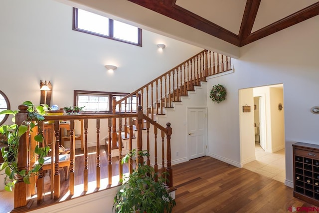101 E Silver Sage Dr, Crested Butte, CO 81224 - stairs featuring high vaulted ceiling, wood finished floors, healthy amount of natural light, and baseboards