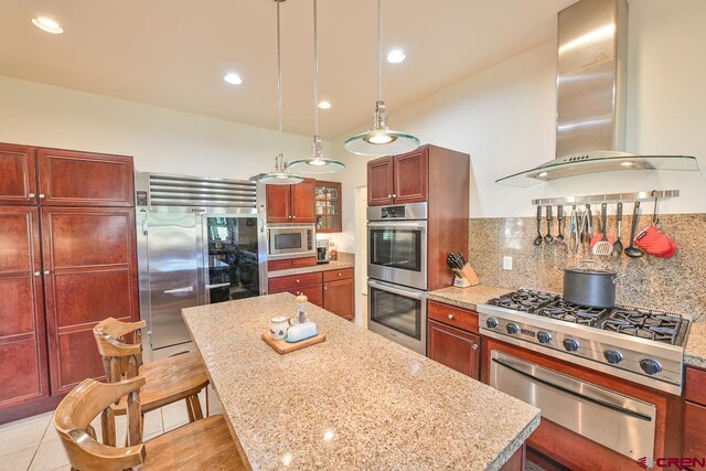101 E Silver Sage Dr, Crested Butte, CO 81224 - kitchen with built in appliances, a warming drawer, wall chimney exhaust hood, a center island, and decorative backsplash