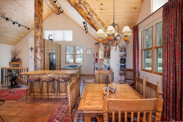 536 Journeys End Rd, Crested Butte, CO 81224 - dining space with wood ceiling with exposed beams, a chandelier, tile patterned floors, track lighting, and high vaulted ceiling