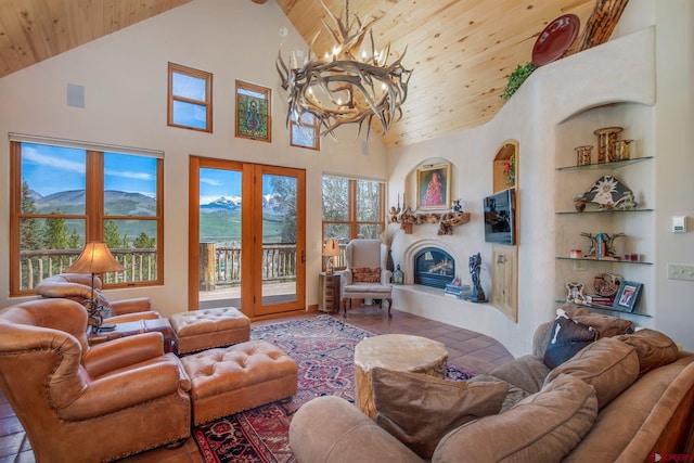 536 Journeys End Rd, Crested Butte, CO 81224 - living area featuring wooden ceiling, high vaulted ceiling, a chandelier, a glass covered fireplace, and a mountain view