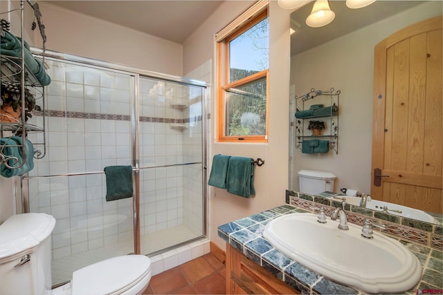 536 Journeys End Rd, Crested Butte, CO 81224 - bathroom with toilet, a shower stall, vanity, and tile patterned floors