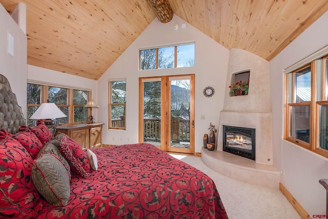 536 Journeys End Rd, Crested Butte, CO 81224 - bedroom with carpet flooring, access to outside, wood ceiling with exposed beams, multiple windows, and a fireplace