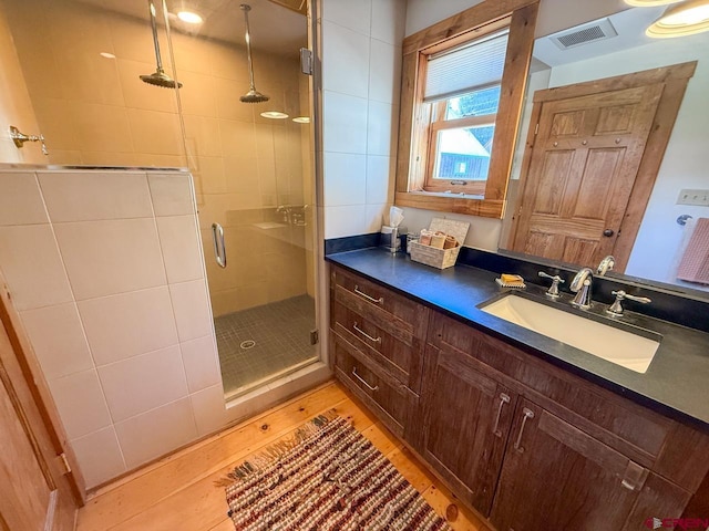 414 Maroon Ave, Crested Butte, CO 81224 - full bathroom with a shower stall, wood finished floors, and vanity