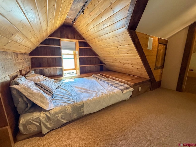 414 Maroon Ave, Crested Butte, CO 81224 - bedroom with wooden ceiling, lofted ceiling, wood walls, rail lighting, and carpet