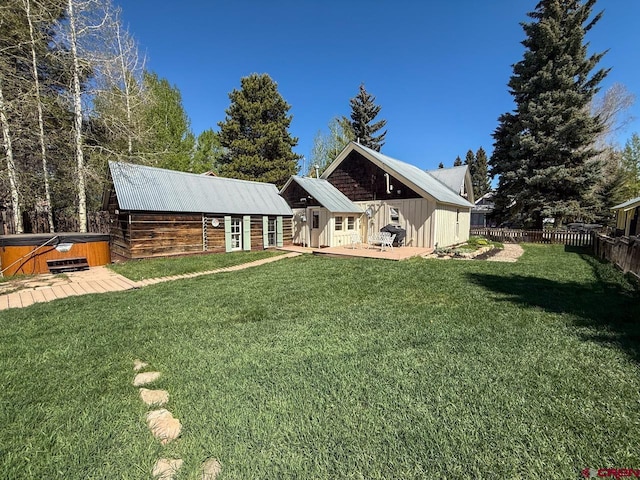 414 Maroon Ave, Crested Butte, CO 81224 - back of property featuring a hot tub, a wooden deck, and metal roof