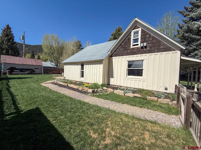 414 Maroon Ave, Crested Butte, CO 81224 - view of property exterior with board and batten siding and a lawn