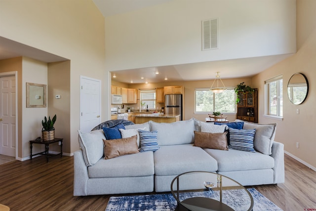 311 Falcon Dr, Pagosa Springs, CO 81147 - living room featuring wood finished floors, baseboards, and a high ceiling