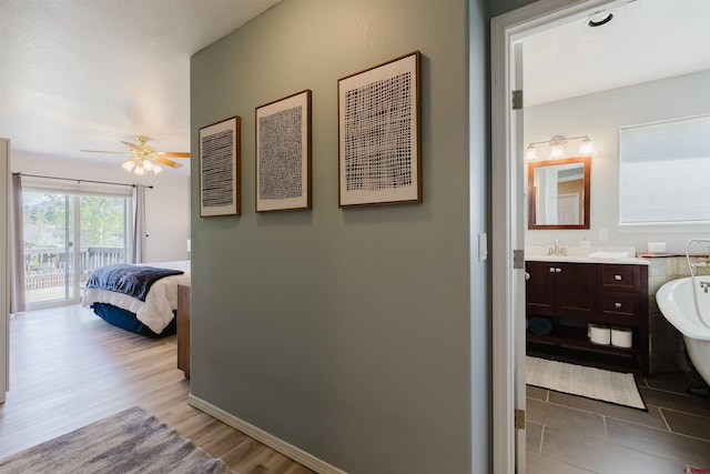 311 Falcon Dr, Pagosa Springs, CO 81147 - hallway featuring wood finished floors, baseboards, and a sink