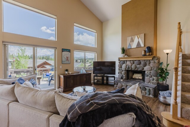 311 Falcon Dr, Pagosa Springs, CO 81147 - living room featuring wood finished floors, high vaulted ceiling, and a stone fireplace
