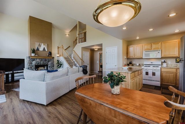 311 Falcon Dr, Pagosa Springs, CO 81147 - kitchen with white appliances, light brown cabinets, a kitchen island, dark wood finished floors, and recessed lighting