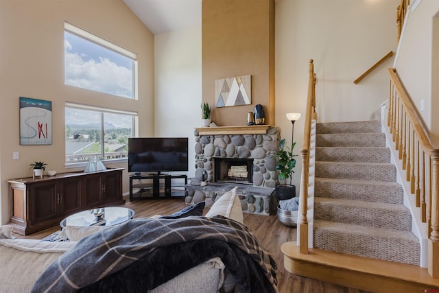 311 Falcon Dr, Pagosa Springs, CO 81147 - living room with wood finished floors, stairway, and a stone fireplace
